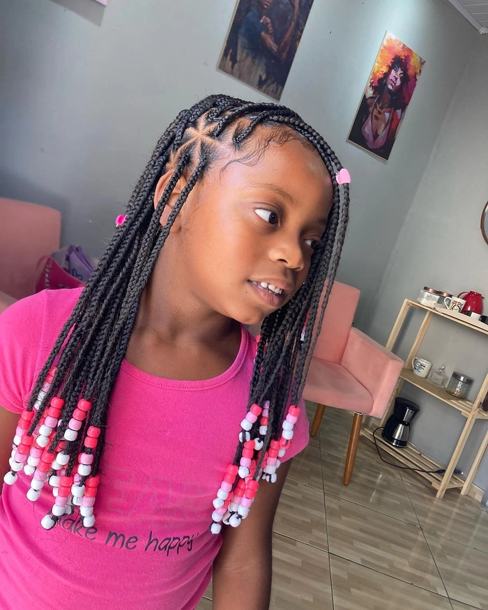 Little girl beach braids – perfect hairstyle for a day by the sea Little girl with braided hair smiling on the sunny beach