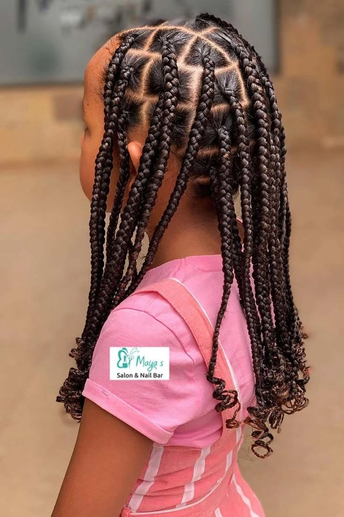 Beach hairstyles for little girls featuring cute braids Little girl with beach braids playing in the sand