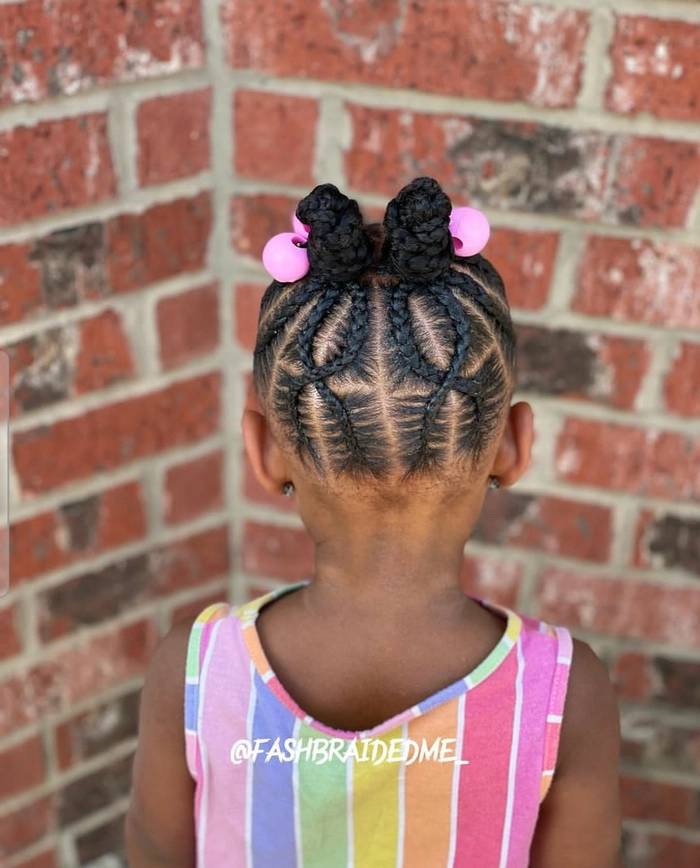 Beachy braids hairstyle for a little girl at the shore Little girl with braided hair smiling at the beach