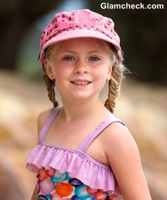 Beach Hairstyles - Little Girl with Braids at the Shore Image 7 Little girl with beach braids playing in the sand near the ocean