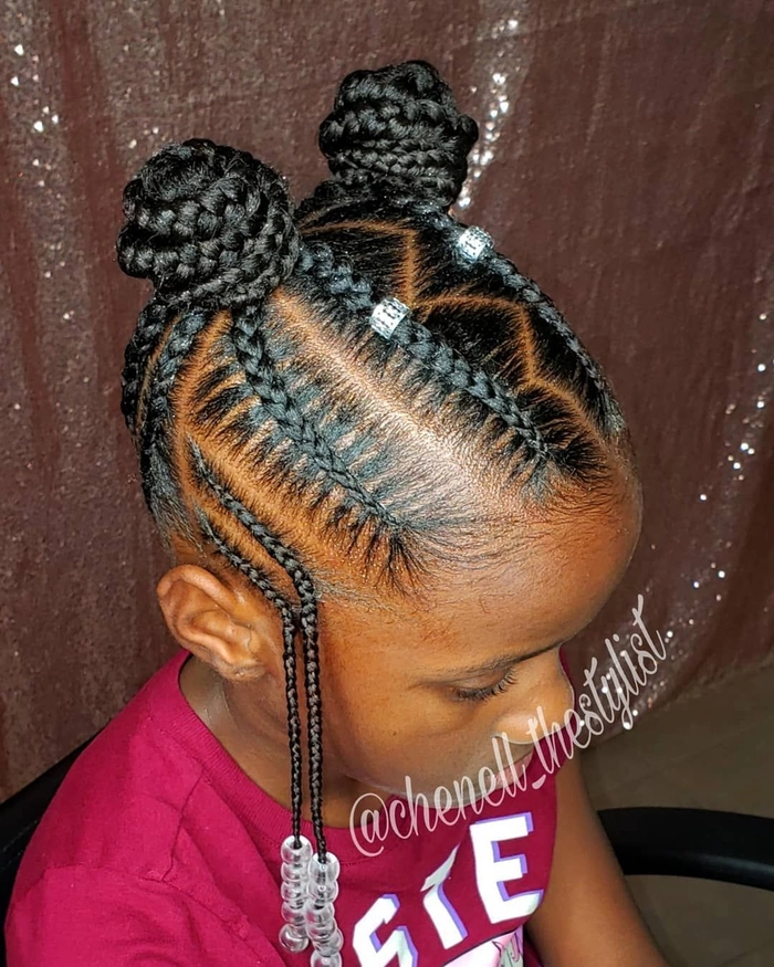 Beach braids hairstyle for a little girl at the shore Little girl with beach braids smiling in the sun