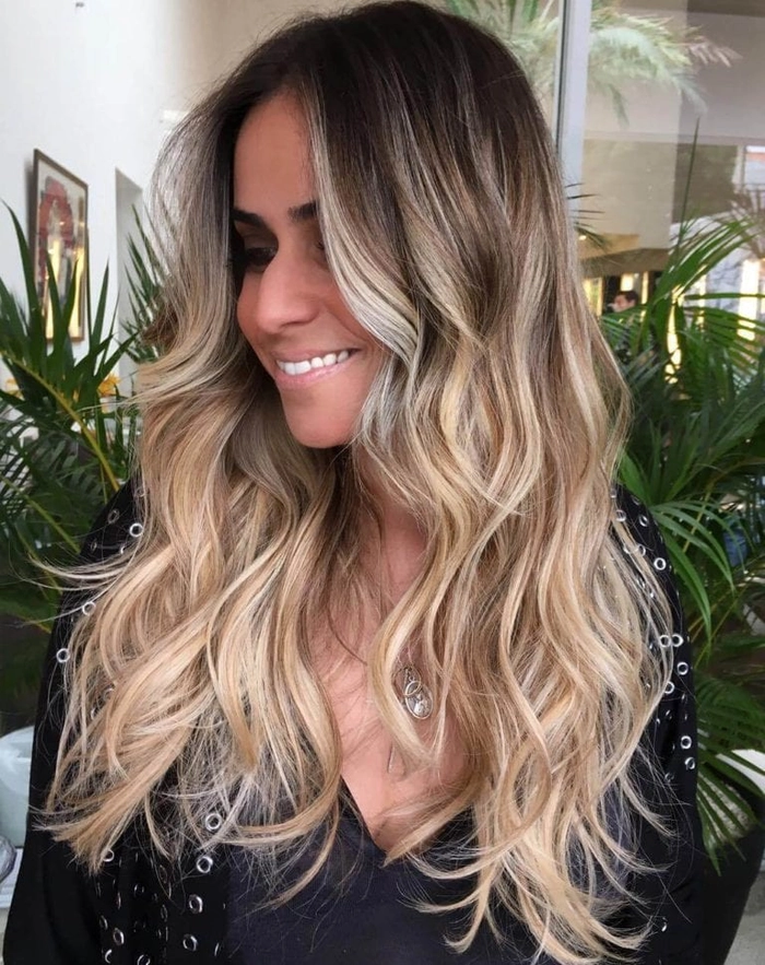 Textured lob beach waves with soft curls cascading over shoulders