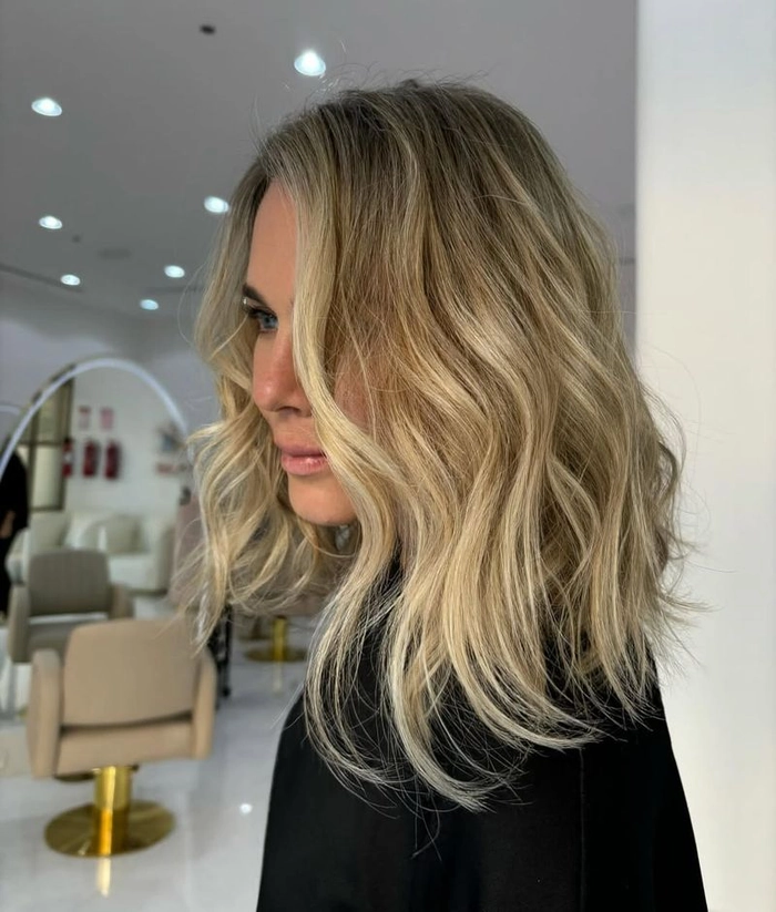 Woman with a tousled lob hairstyle featuring beach waves