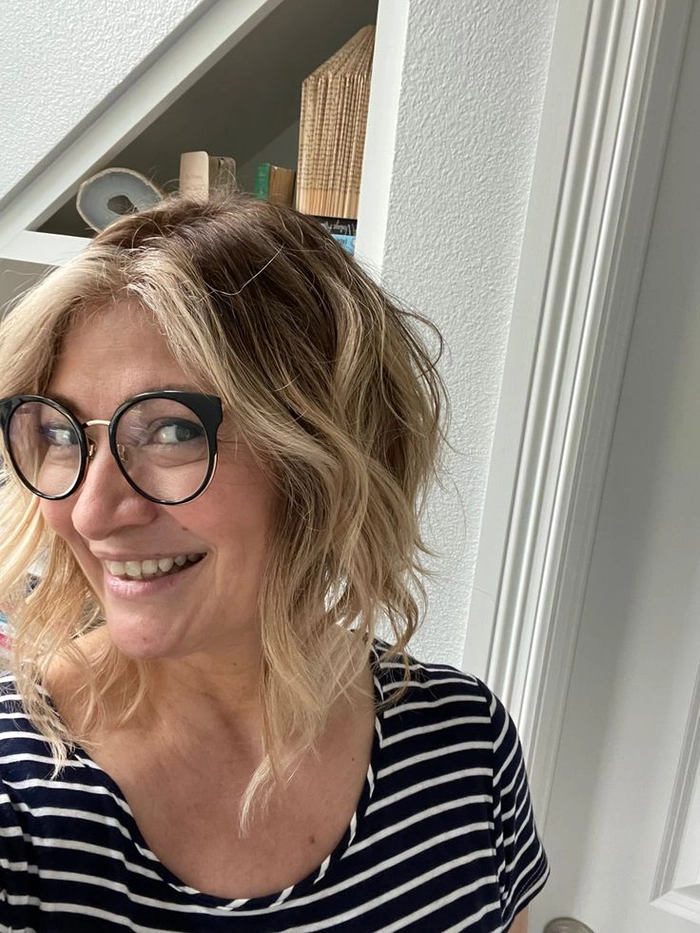 Woman with tousled lob beach waves, perfect for summer beach style