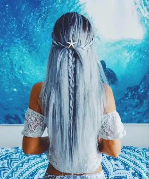 Long mermaid-inspired waves flowing at the beach with sandy highlights