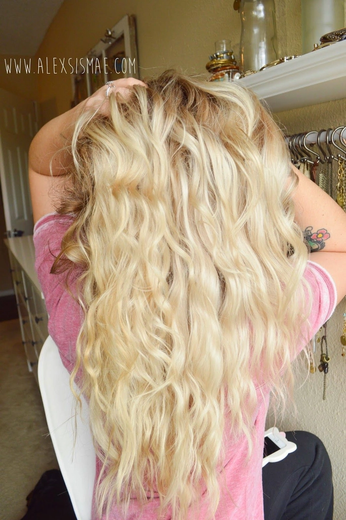Woman with voluminous beach waves from overnight braiding technique