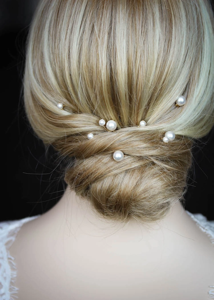 Pearl hair pins securing a beach updo with soft, tousled waves