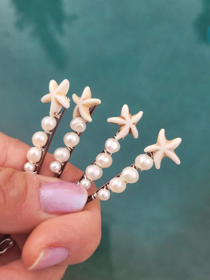 Pearl hair pins accent a romantic beach updo with soft waves.