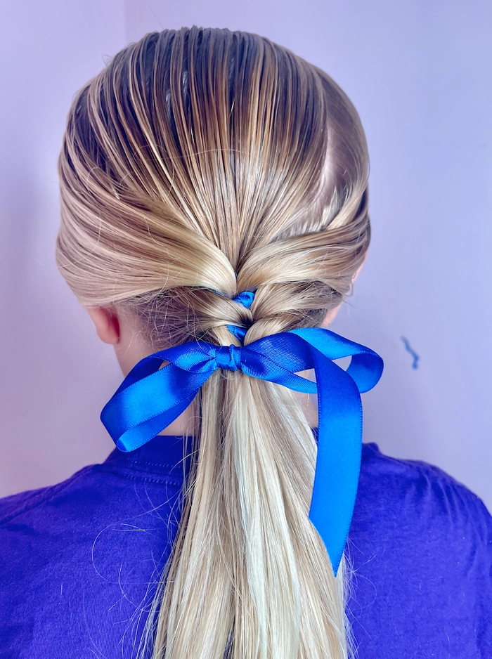 Two ribbon-tied beach braids with soft waves framing the face