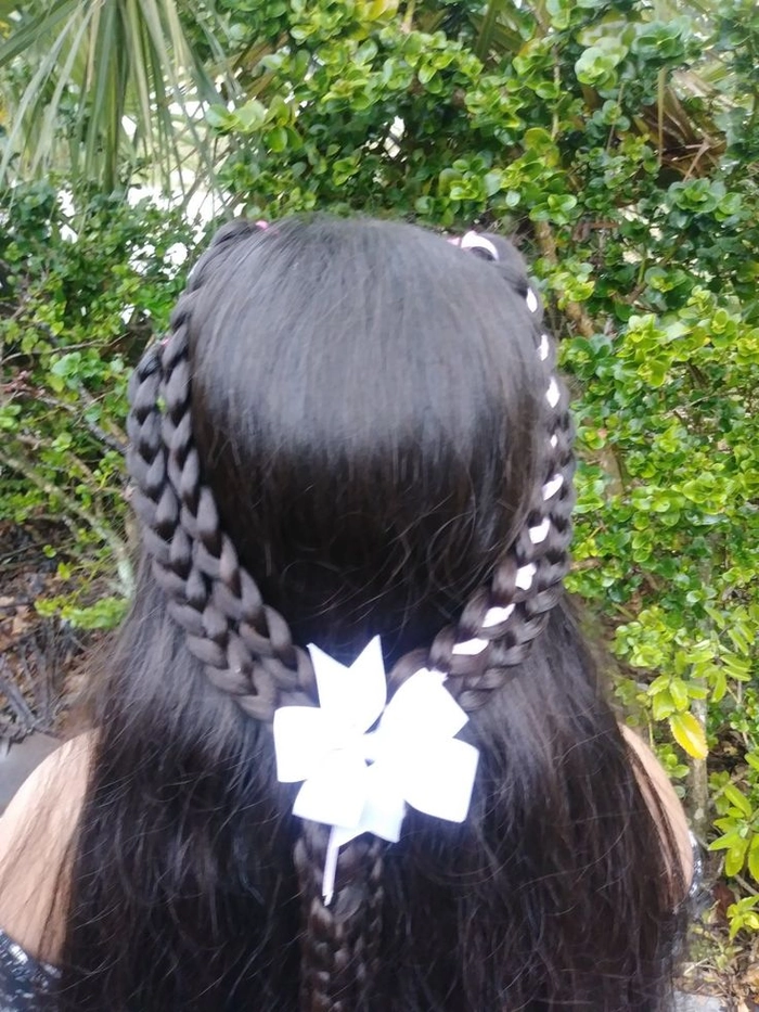 Ribbon tied beach braids hairstyle with colorful ribbons woven into braids