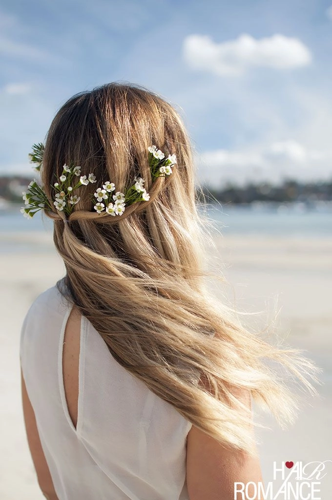 Romantic beach hair with flowers cascading over soft waves