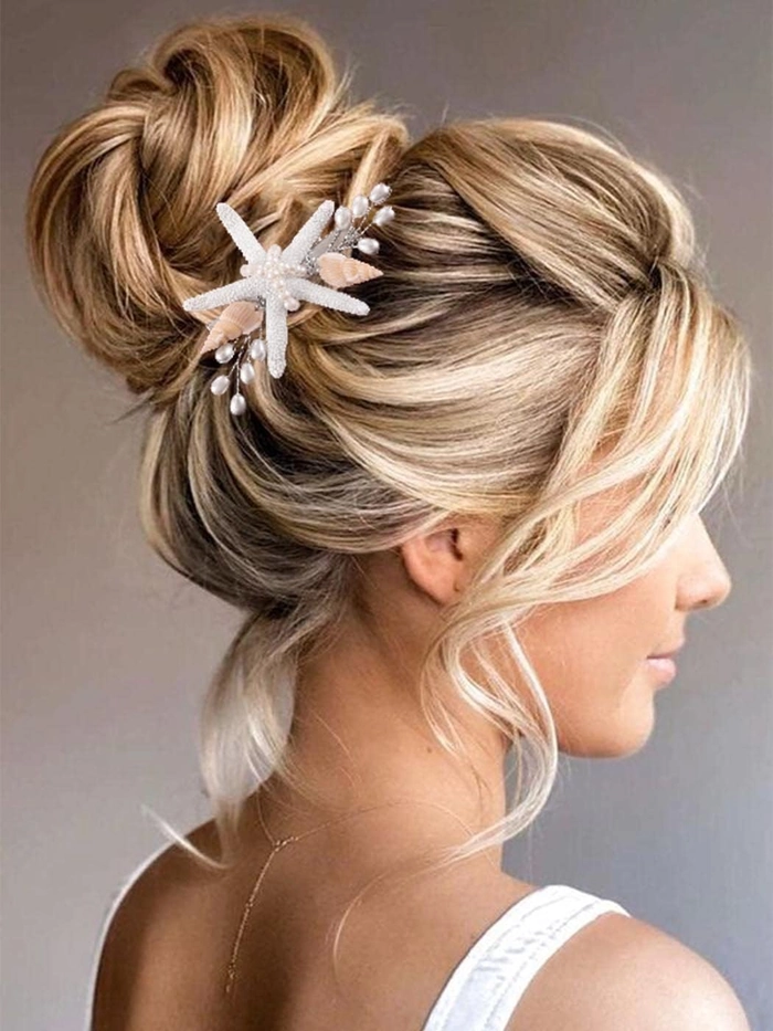 Bride wearing a seashell hair clip with loose beach waves and a floral crown
