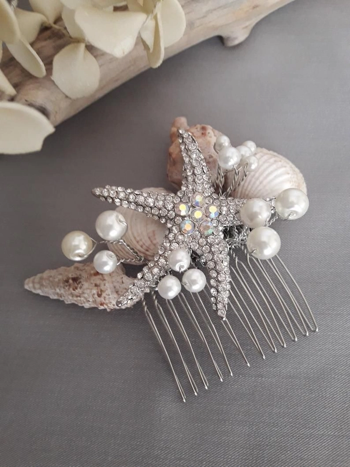 Bride wearing seashell hairpins in a beach wedding updo