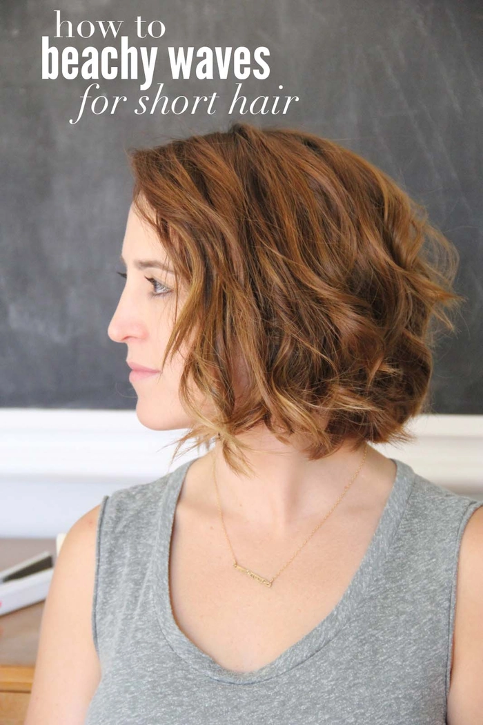 Woman with straight hair styled into beach waves using a curling wand