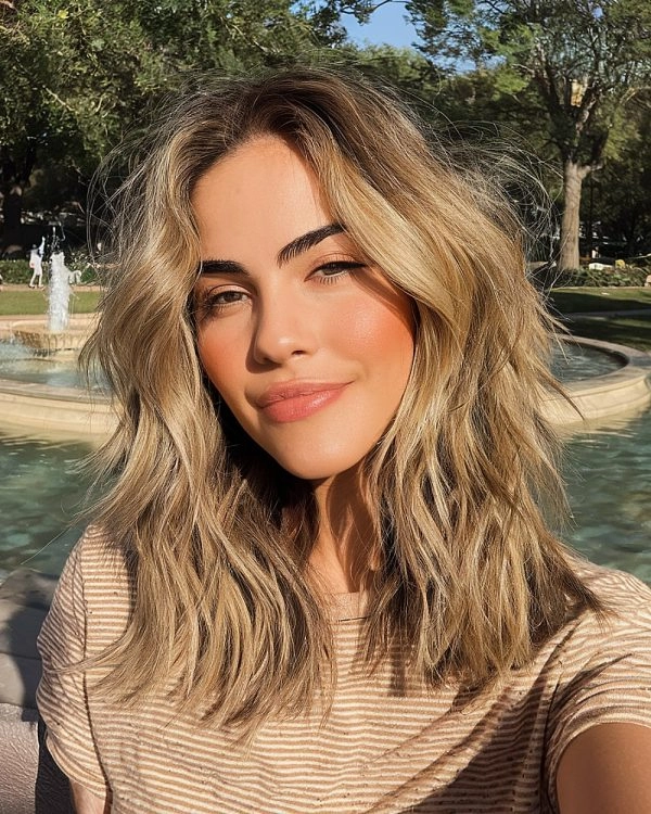 Sun-bleached beach waves flowing in ocean breeze with salt spray sheen