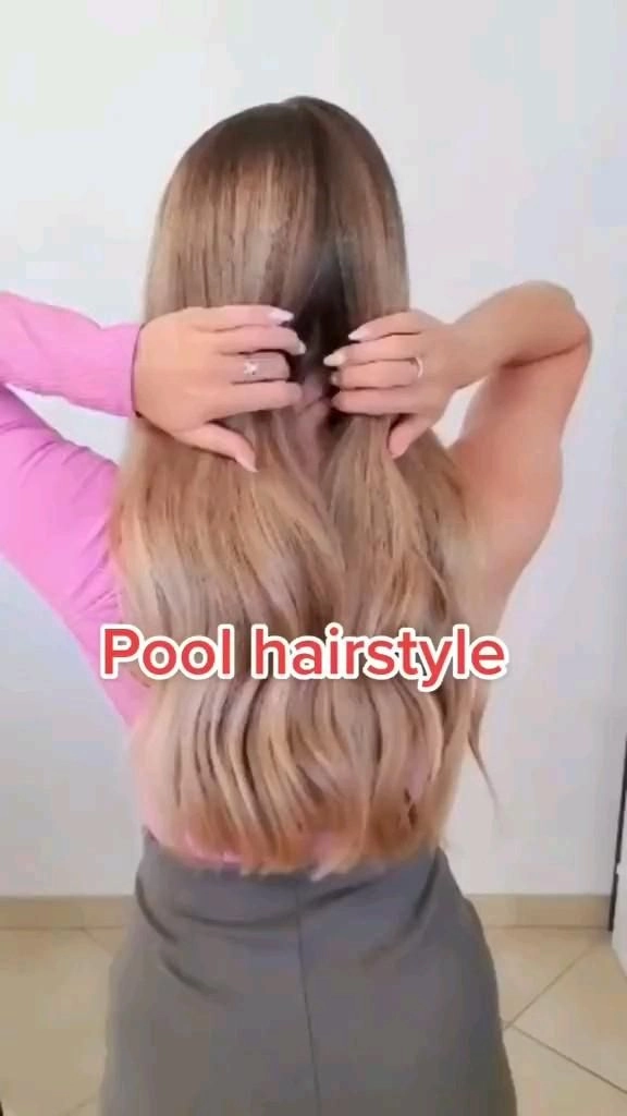 Woman transitioning her wet hair from pool to beach style with tousled waves