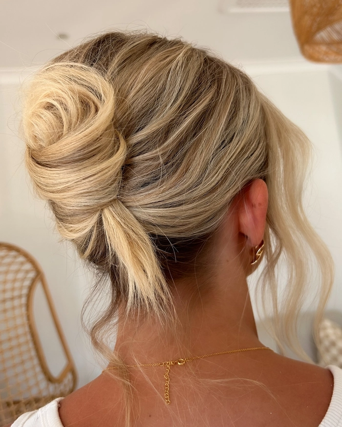 Natural thick hair beach updo with loose tendrils and sea salt texture