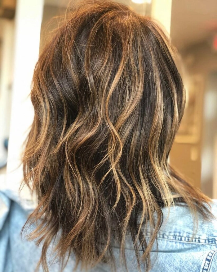 Woman with thin hair applying sea salt spray for beachy waves
