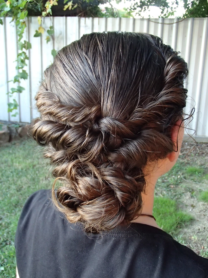 Beach updo hairstyle concept featuring twisted sections and natural texture Twisted beach updo with soft twists and ocean waves