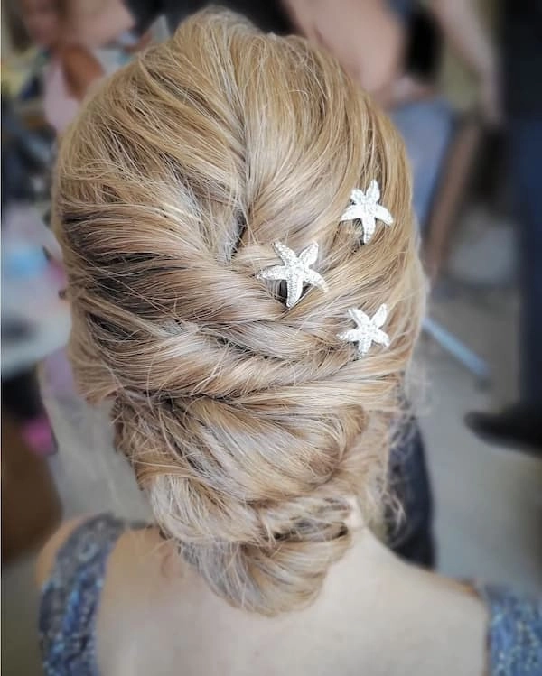 Twisted Beach Updo Hairstyle Concept for Breezy Summer Days A twisted beach updo with soft waves and braided details for a romantic seaside look