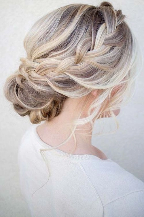 Twisted Beach Updo Concept 6 - Effortless Boho Style for Summer Waves A woman with a twisted beach updo, wavy hair pinned in a loose bun with subtle waves and sea-kissed texture.
