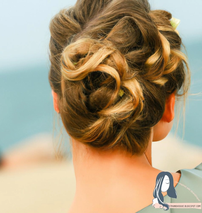 Twisted beach updo with braided accent and natural sea-swept texture Close-up of a twisted beach updo with loose waves and braided detail