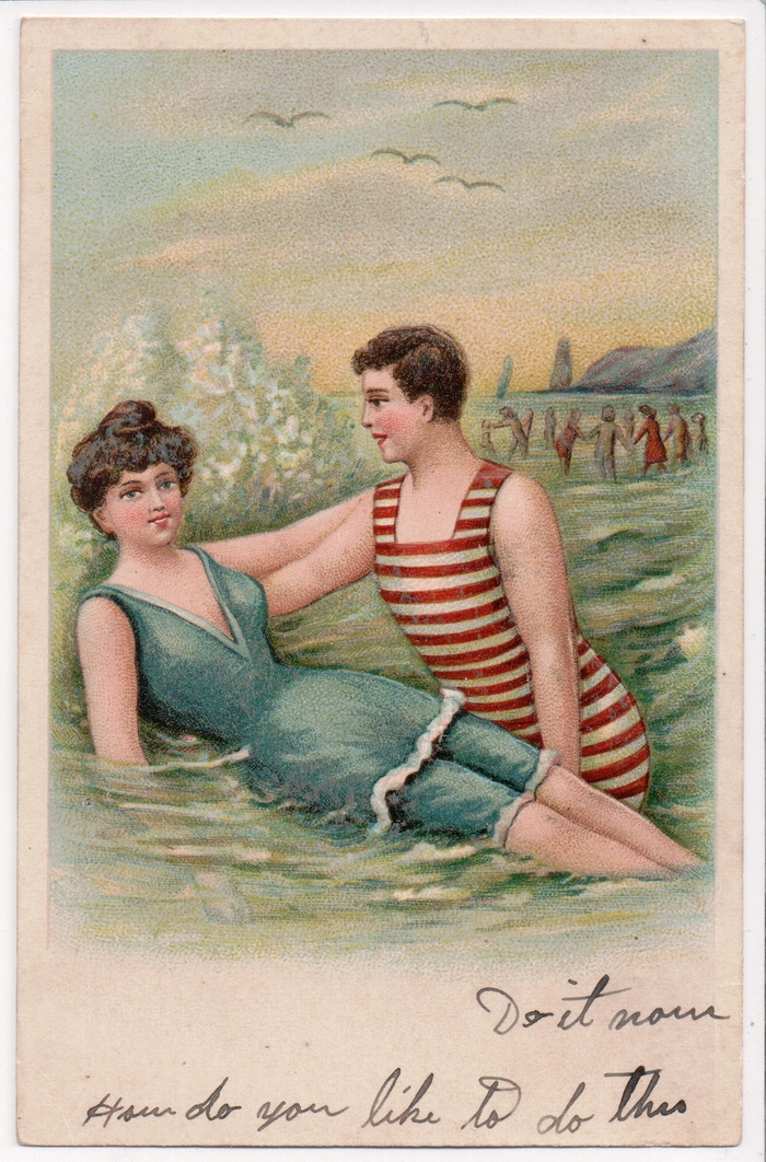 Woman with vintage pinup curls and red flower at beach