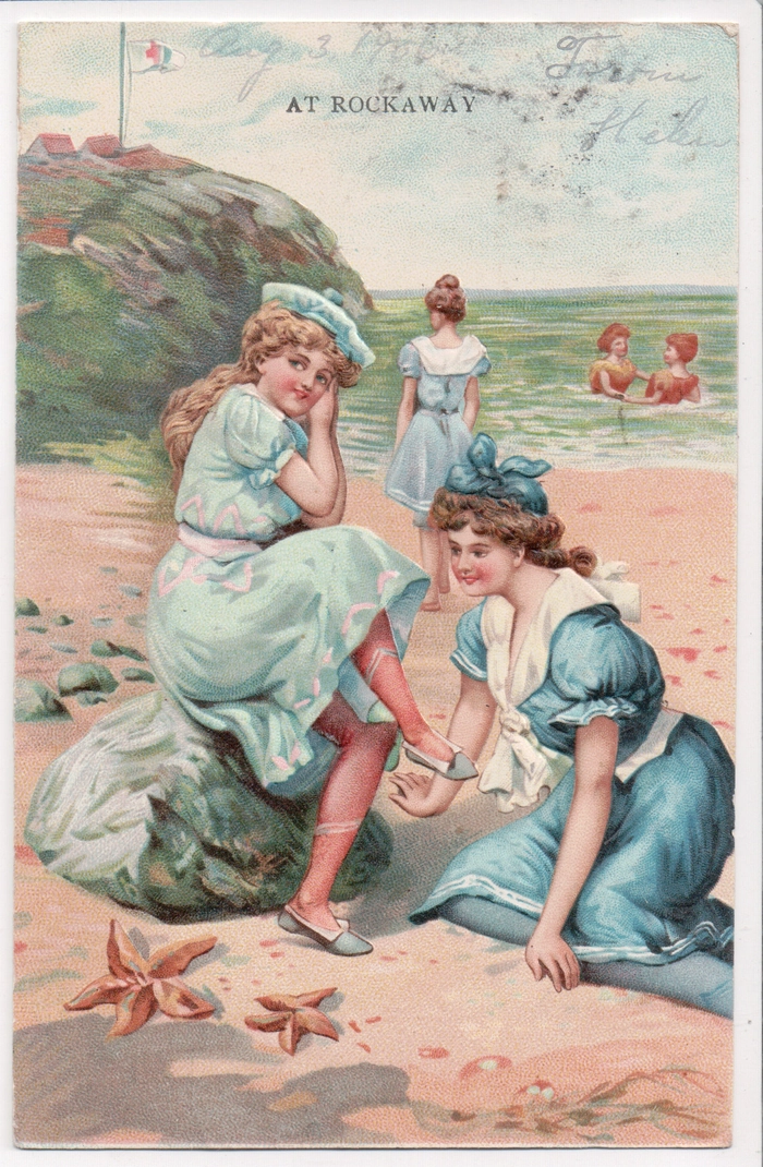 Woman with a classic vintage pinup beach hairstyle enjoying the sun at a seaside boardwalk