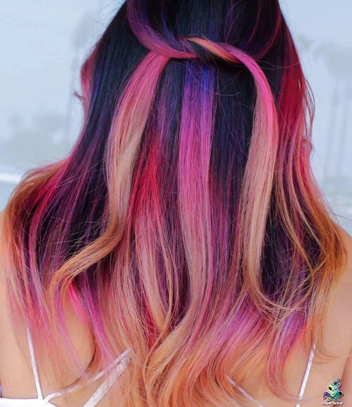 Woman with bright rainbow-colored beach waves and a sun-kissed glow