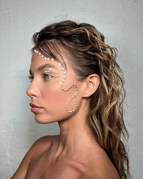 Woman with wavy wet look beach hair styled with salt spray and textured layers