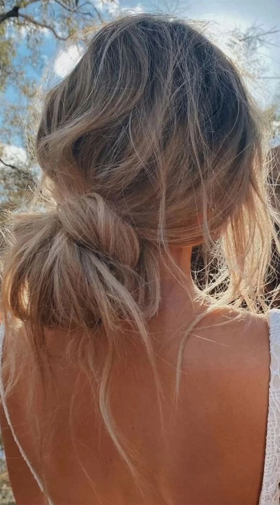 Windproof beach hairstyle featuring a low bun and headband