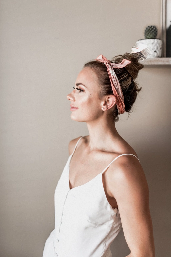 Simple bandana top knot for casual summer festivals hairstyle tutorial step fourteen Woman wearing a simple bandana top knot hairstyle perfect for casual summer festivals