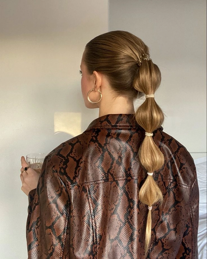 Casual bubble braid ponytail hairstyle on long hair with loose waves