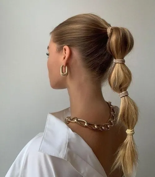 Casual bubble braid ponytail hairstyle on long hair with soft waves