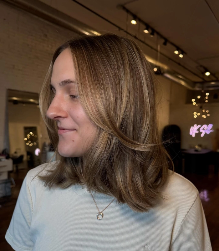Casual everyday lob hairstyle featuring soft curtain bangs and natural waves