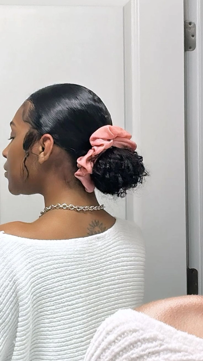 Easy slicked back bun hairstyle for curly hair with a casual finish