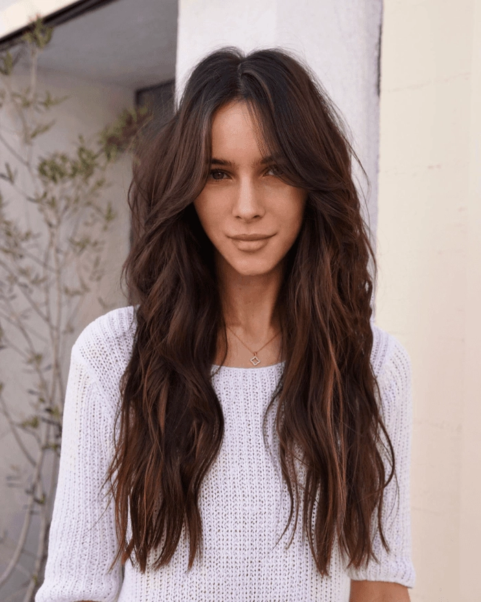 effortless layered curtain bangs styled with casual loose waves