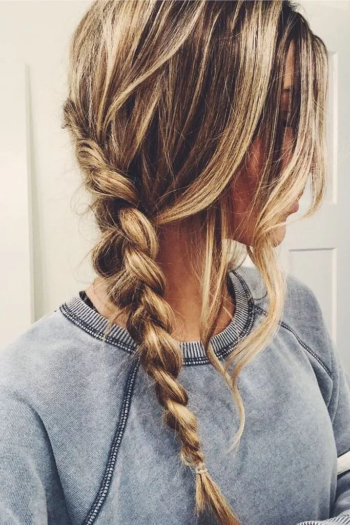 Effortless loose side braid hairstyle for a casual autumn walk outdoors
