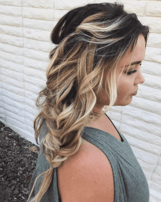 Effortless loose side braid hairstyle perfect for a casual autumn walk amidst colorful leaves