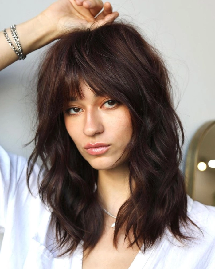 Casual weekend styling of a chic shag haircut for easy, carefree vibes Effortless shag haircut styled with loose waves for a relaxed weekend look