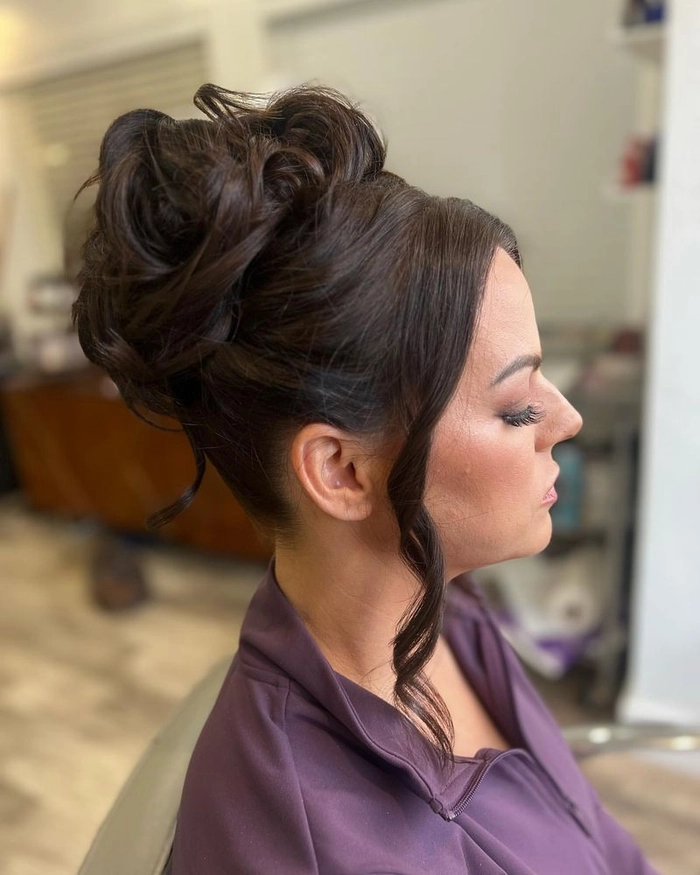 Elegant relaxed low bun hairstyle on a woman over 40 with casual outfit