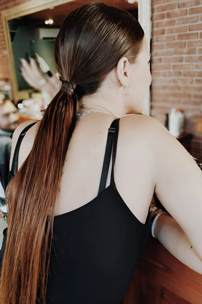Casual hairstyle inspiration featuring a simple low ponytail for an effortless look Everyday sleek low ponytail styled for minimalist casual outfits on a woman