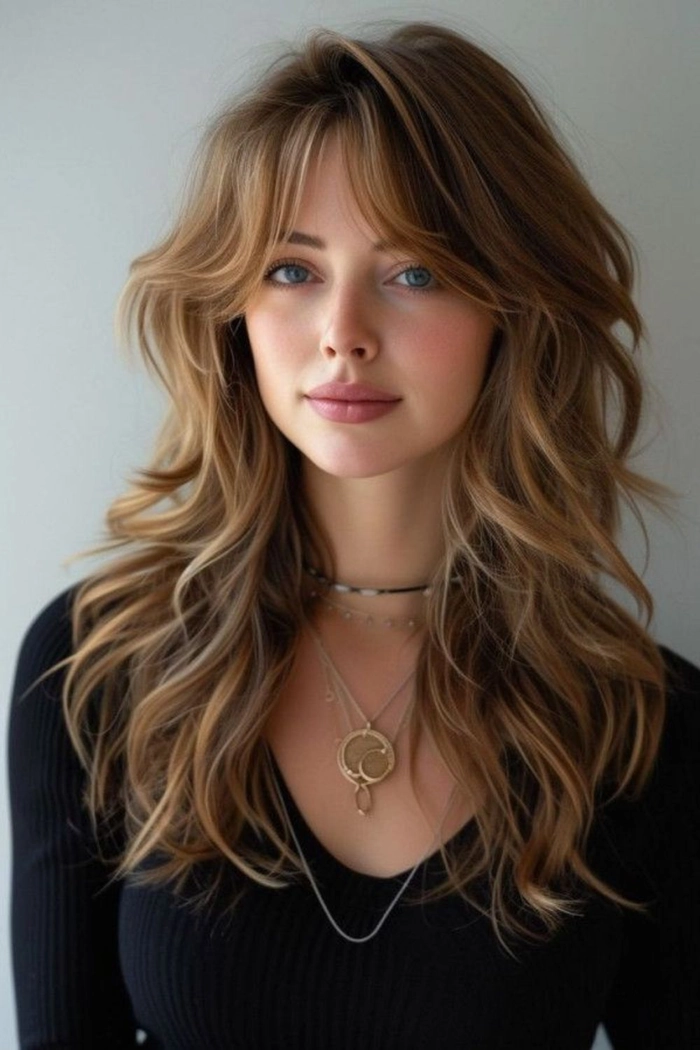 Effortless layered curtain bangs with casual loose waves for a soft, natural hairstyle