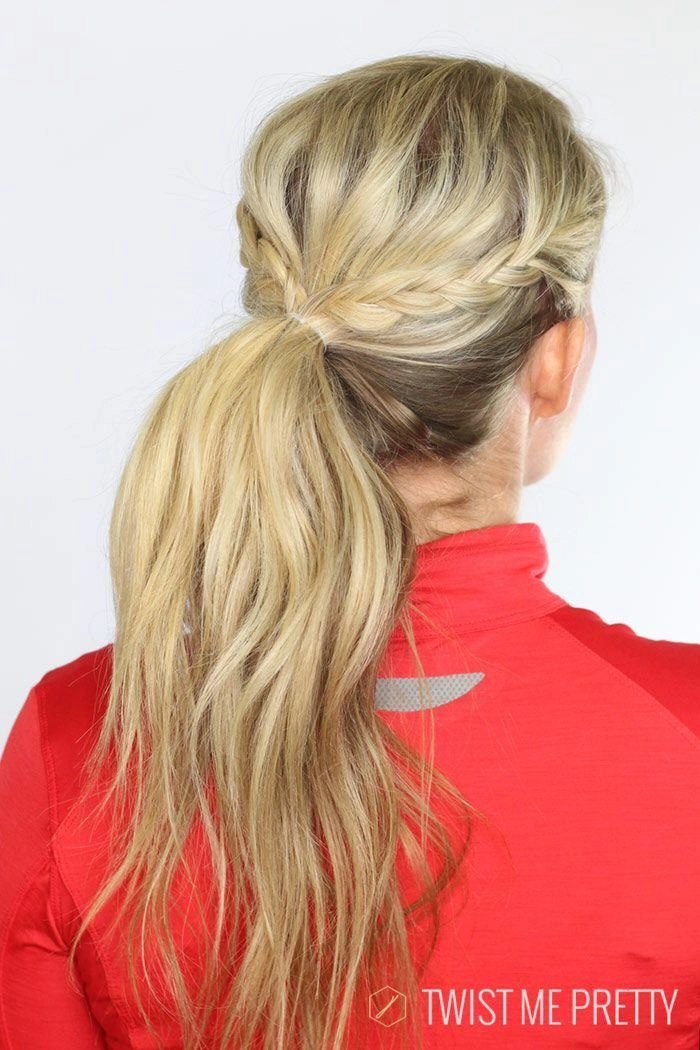 Quick knot hairstyle for easy post-workout transitions Woman with a messy quick knot hairstyle ideal for post-workout transitions in casual settings