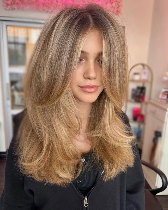 Everyday layered hair styling creating natural volume with soft waves