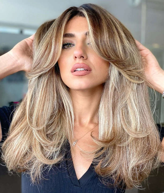 Everyday layered hair styling creating natural volume with soft waves