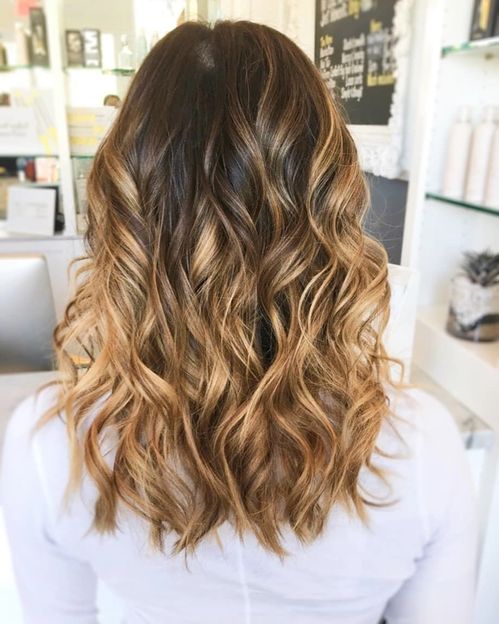 Casual medium length hairstyle featuring soft and relaxed loose curls Medium length hair styled in relaxed loose curls for a natural, casual look