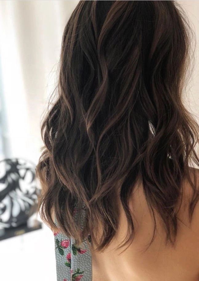 Casual hairstyles featuring soft, relaxed loose curls on medium hair Medium length hair styled in relaxed loose curls for a casual look