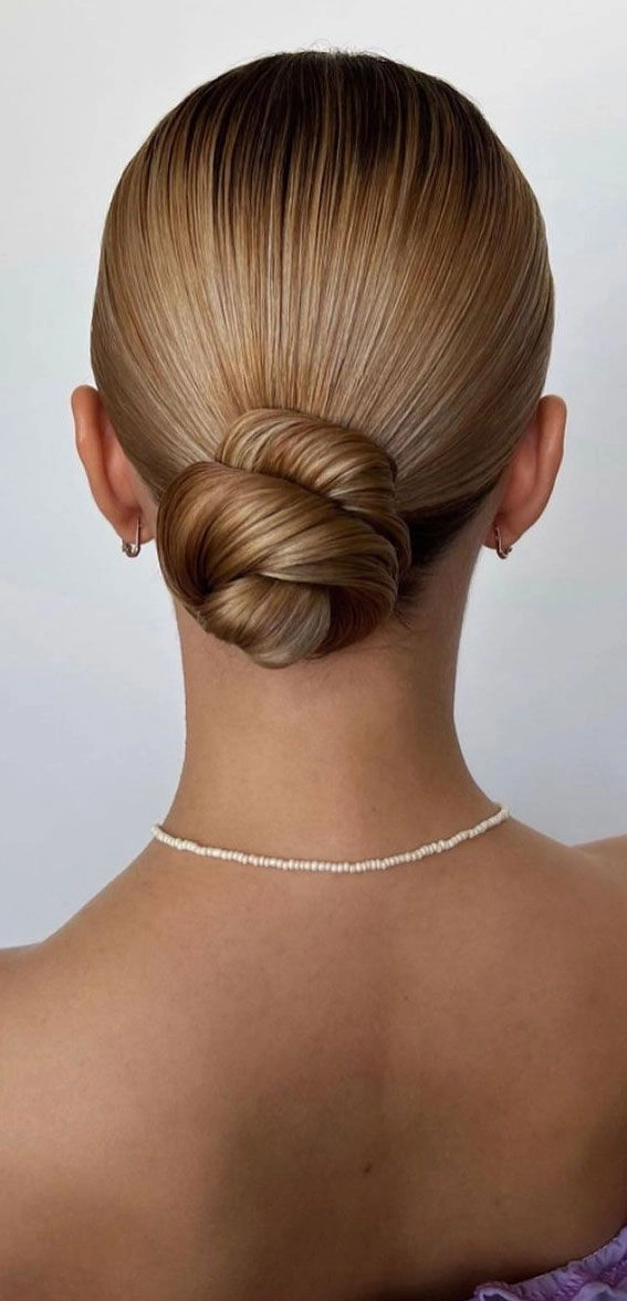Effortless and stylish low twisted bun for everyday work looks Quick low twisted bun hairstyle suitable for professional casual settings