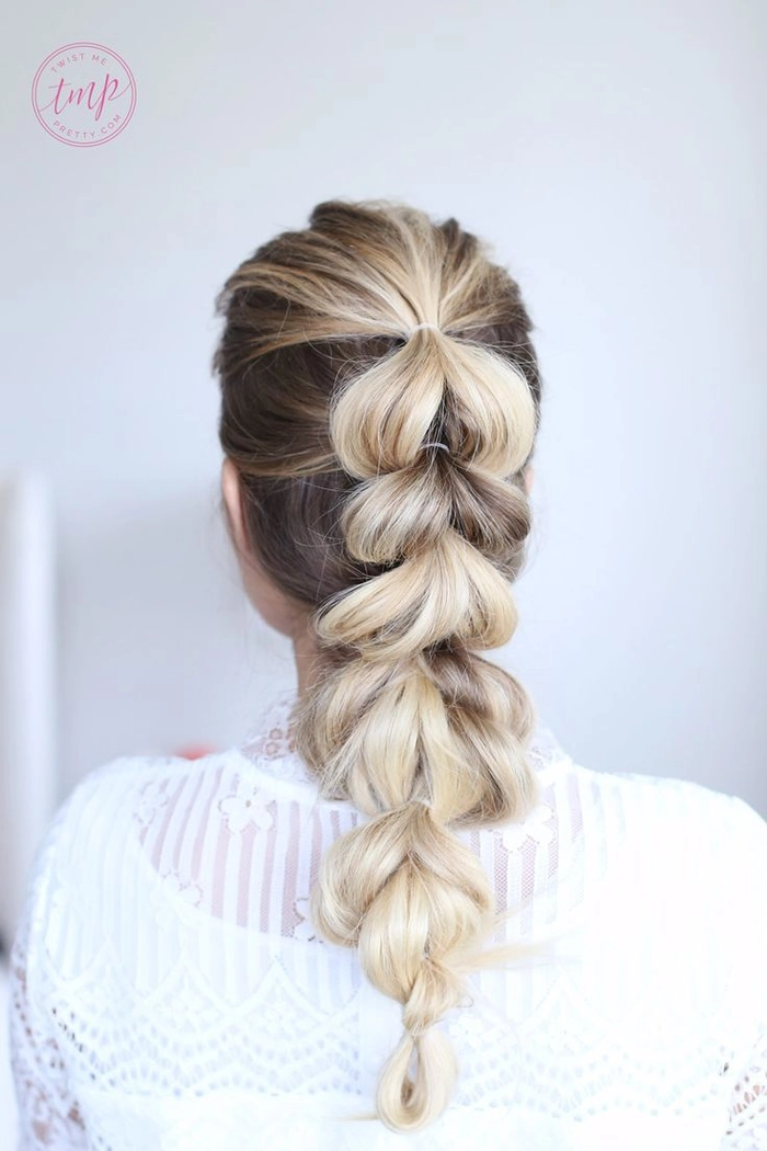 Casual hairstyle featuring a quick pull through braid on dense hair Quick pull through braid style on thick hair for a casual look